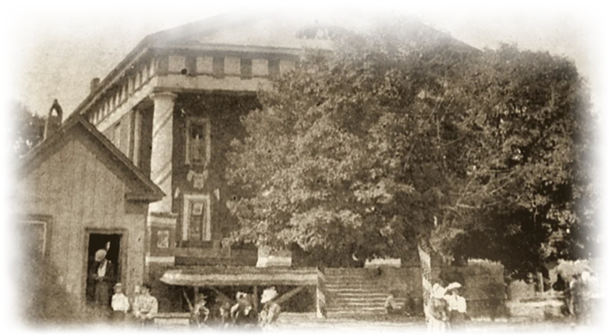 A rarely seen archival close-up of Buckhannon's first courthouse, with townspeople gathered out front